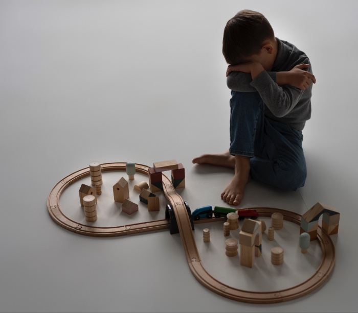 child playing with little trainset 