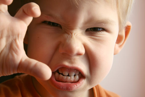 aggresive child baring teeth