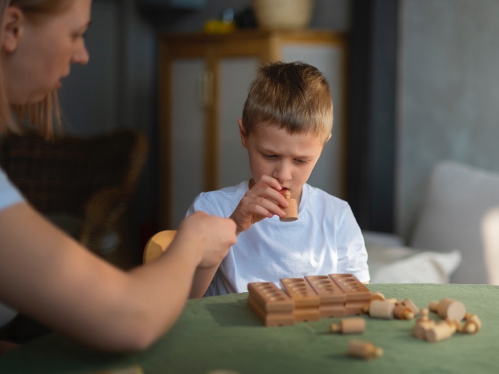 Mother an her Autistic son playing with shapes