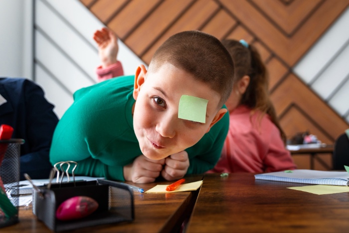 young boy at school showing symptoms of ADHD