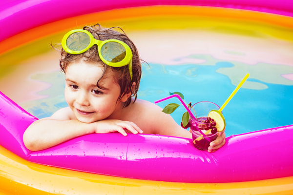child having unstructured time in a paddling pool