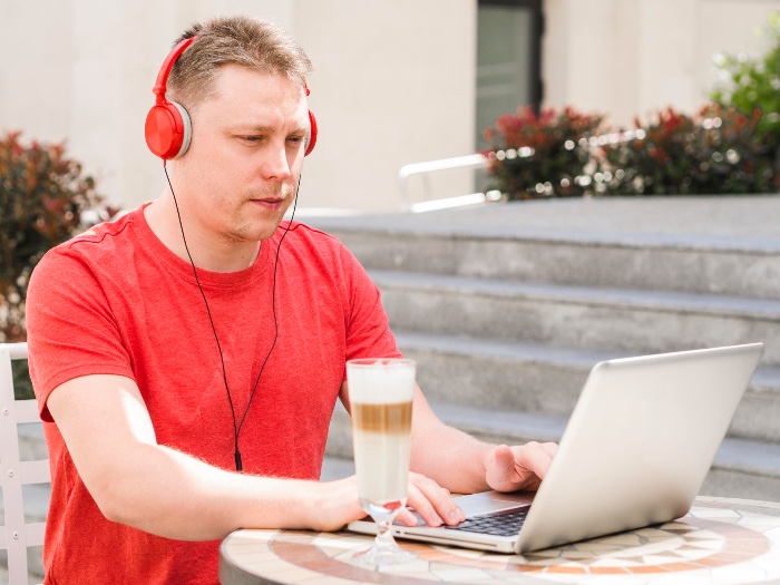 a young man at work using noise cancelling headphones