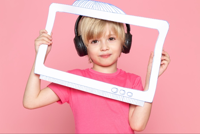 children watching a screen under the bed sheets
