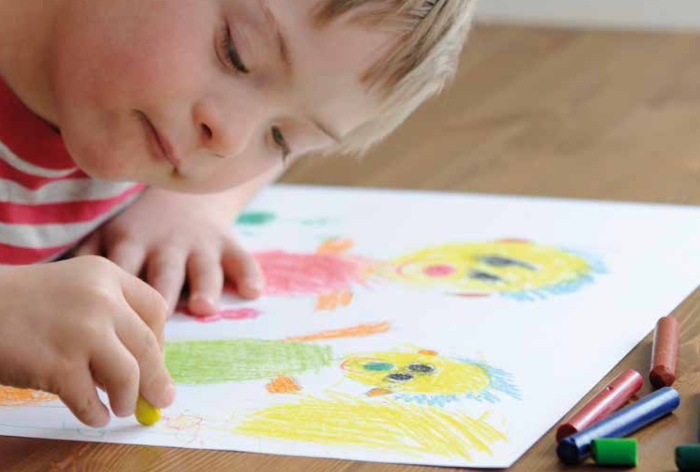 young boy colouring in