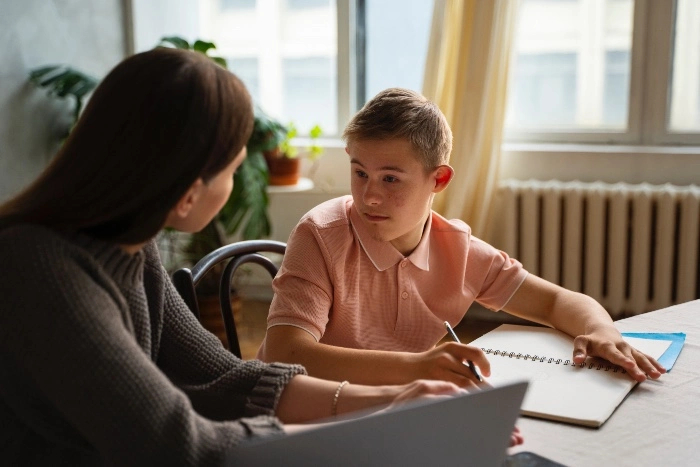 young student receiving support from a teacher