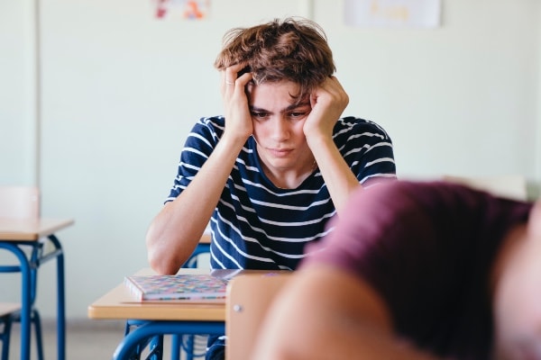 Unhappy student with challenging behaviour in the classroom